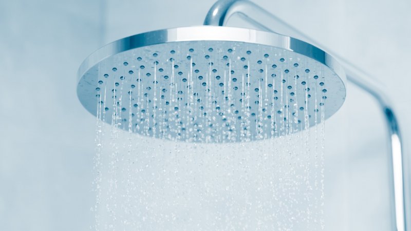 A rain shower head (Photo by coffeekai/iStock / Getty Images Plus via Getty Images)