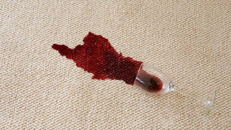 glass with red wine spilled on carpet (Photo by Image Source/Image Source via Getty Images)