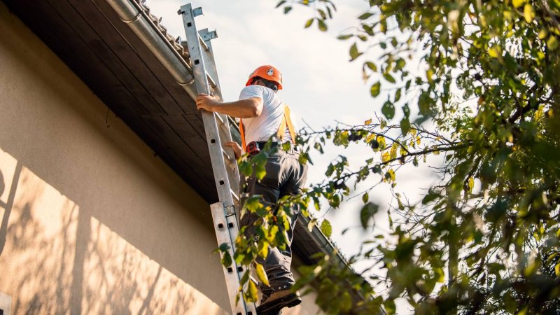 A roofer climbing a ladder (Photo by vitranc/E+ via Getty Images)