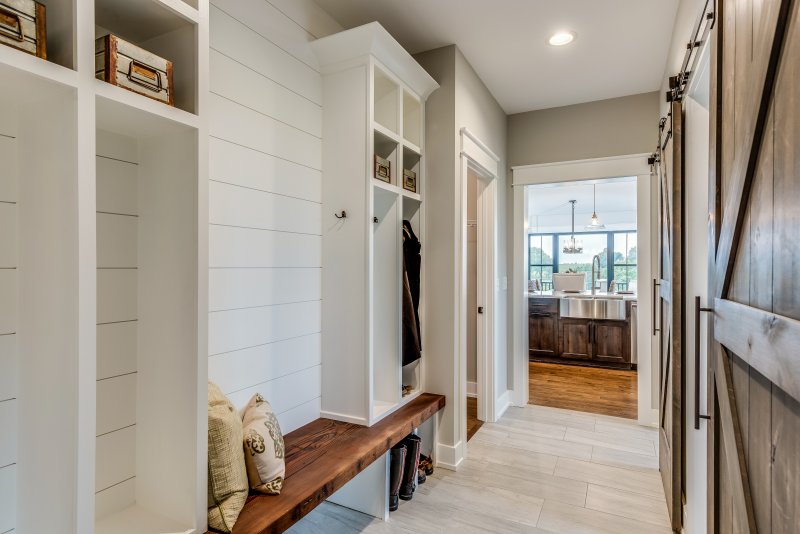 Mudroom with white shiplap wall and wooden bench (Photo by PC Photography /iStock /Getty Images Plus via Getty Images)