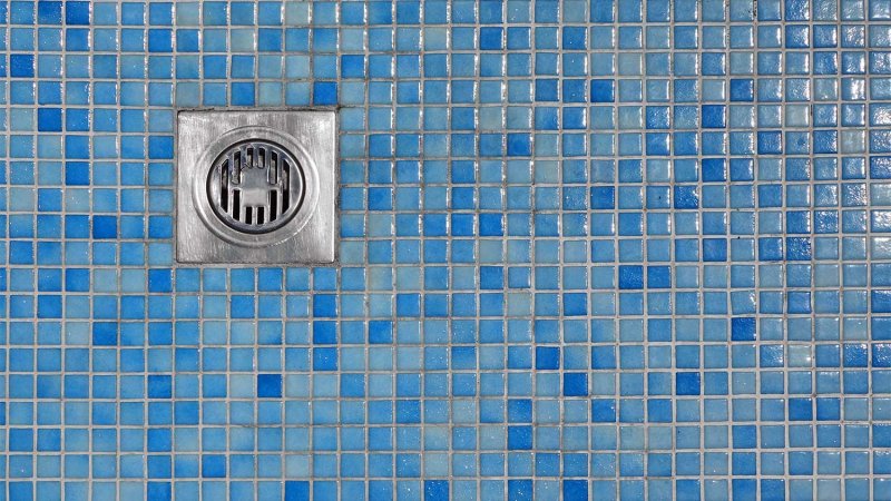 Blue tiled floor shower drain (Photo by Alex - stock.adobe.com)