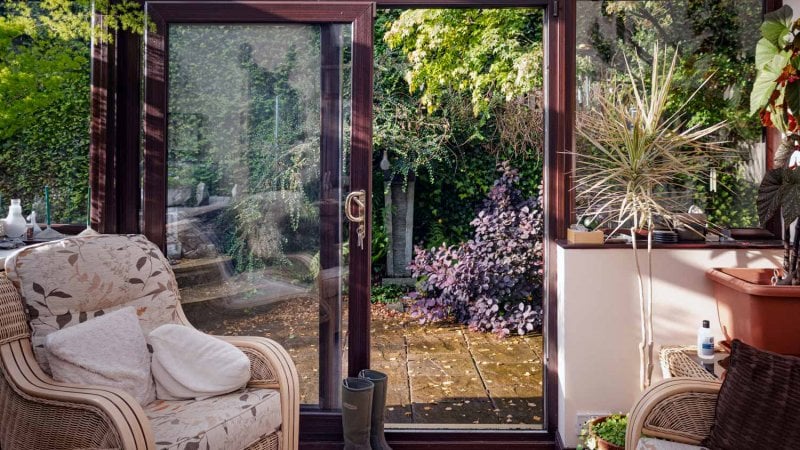 A sliding door leading to a house’s patio (Photo by Pauline Lewis/Moment via Getty Images)