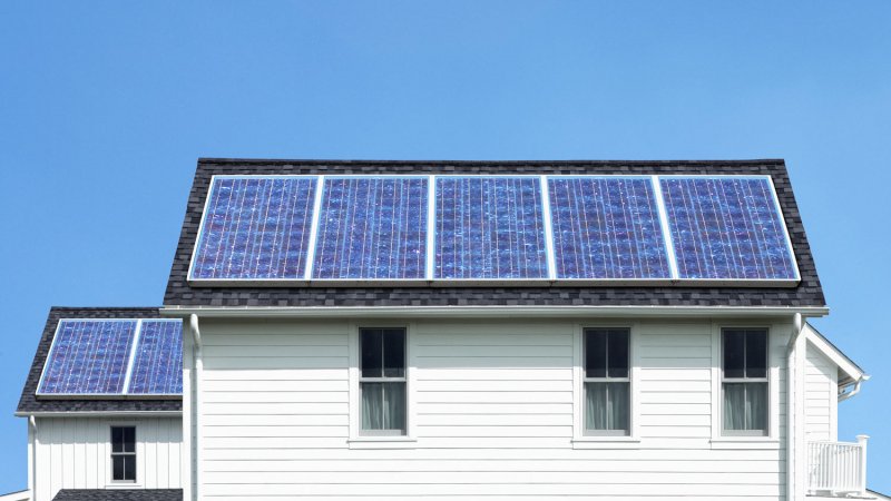 solar panels roof white house (Photo by Steven Puetzer/The Image Bank via Getty Images)