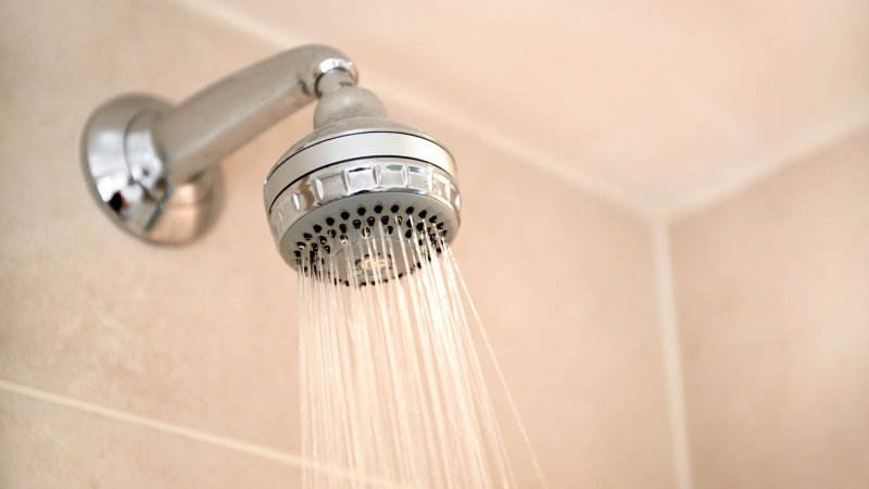 A standard wall mount shower head (Photo by Peter Dazeley/The Image Bank via Getty Images)