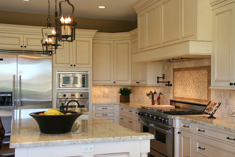 Luxury kitchen with stone and tile backsplash, white cabinets and kitchen island (Photo by Mark Breck - stock.adobe.com)