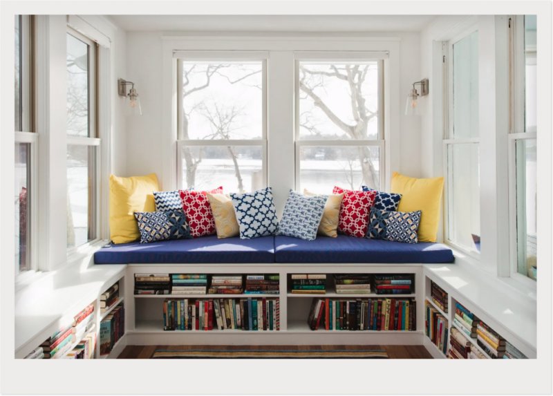 sunroom with mini library in bench (Photo by © Kraus Associates)