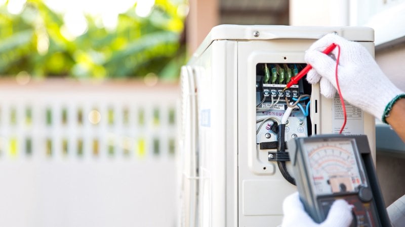 A techinician checking a heat pump (Photo by Eakrin - stock.adobe.com)