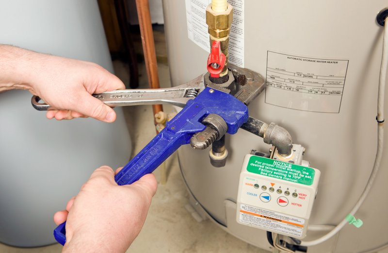 water heater getting repaired (Photo by BanksPhotos/iStock/Getty Images Plus via Getty Images)