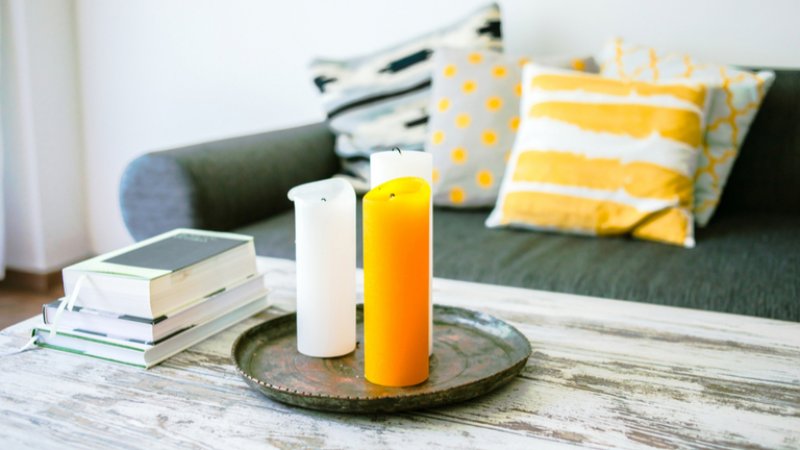 Distressed white coffee table using milk paint with candles and books Distressed white coffee table using milk paint with candles and books (Photo by Yulia Grigoryeva / Shutterstock.com)
