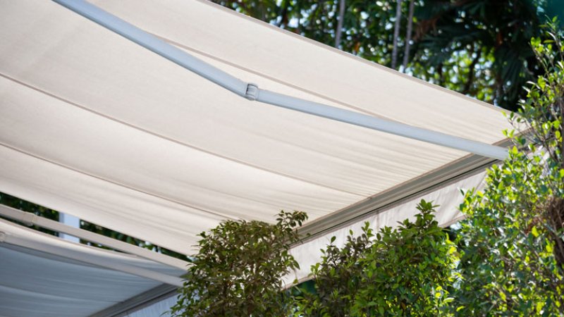 white awning in garden, canvas shading (Photo by Rattanachat - stock.adobe.com.)