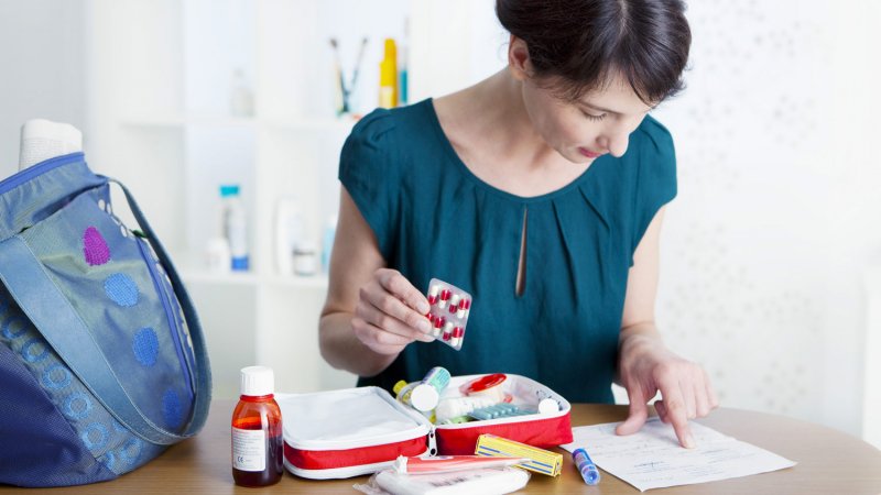 A woman filling up her first aid kit (Photo by RFBSIP - stock.adobe.com)
