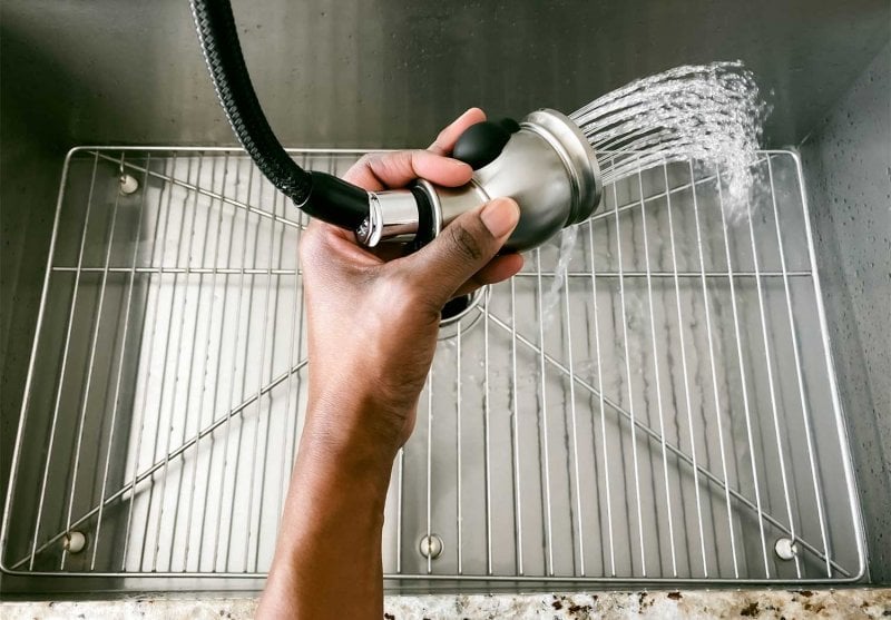 Close up of a woman rinsing kitchen sink (Photo by Grace Cary/Moment via Getty Images)