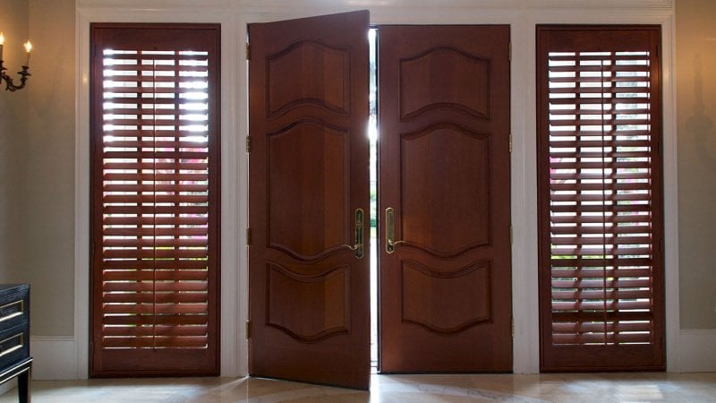 Wood shutters flank front door (Photo by Stephen Orsillo - stock.adobe.com)
