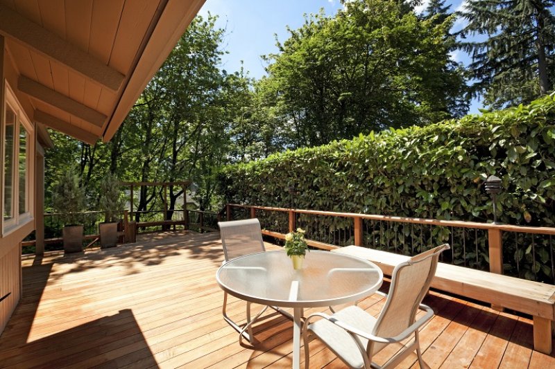 Wooden deck on summer day (Photo by chuckcollier / E+ via Getty Images)