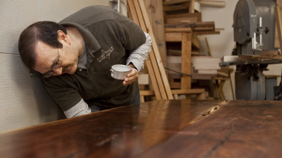 a man working on a wood table