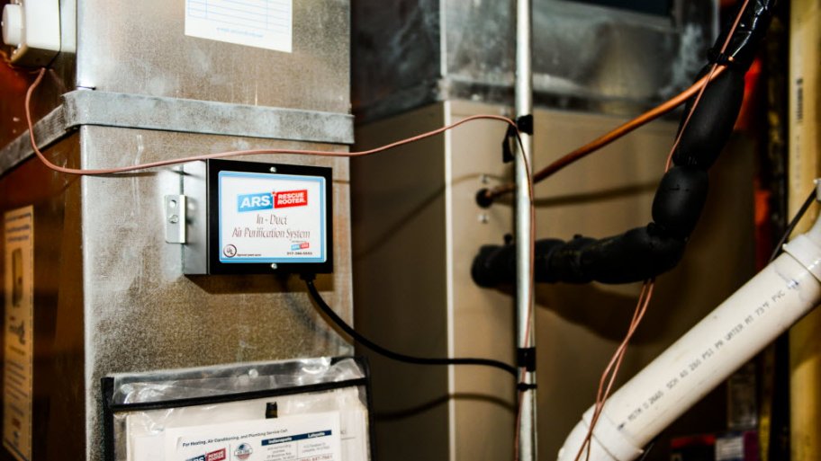 box attached to HVAC system with UV light inside