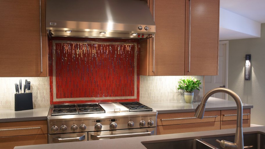 stove and countertop with under cabinet lighting