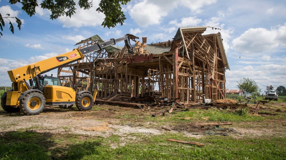 A bulldozer demolishes an old barn in Kokomo, Indiana