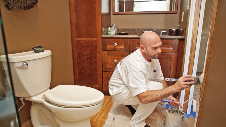 a man painting a bathroom