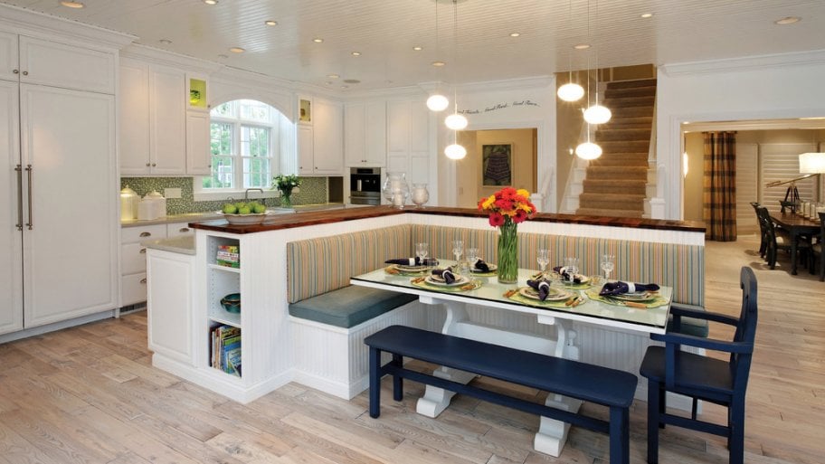 Home with recessed and hanging lights over a kitchen bar