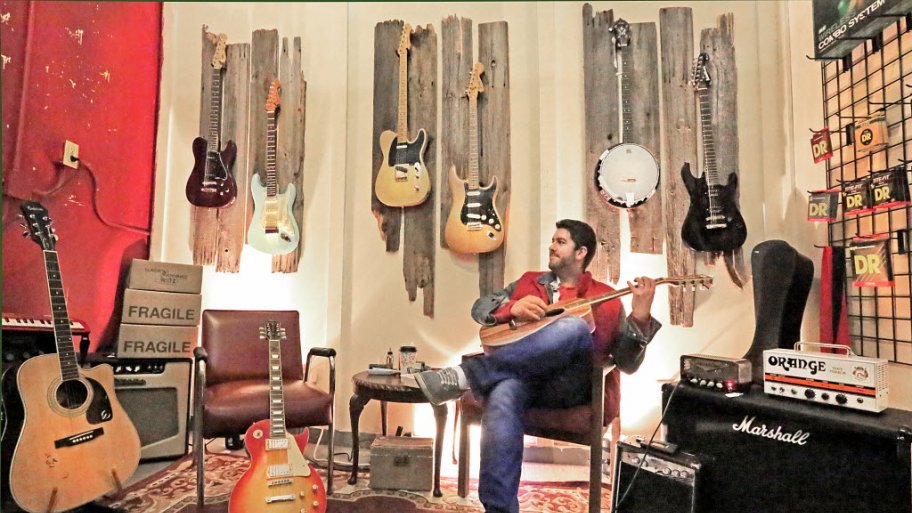 Stephen Cummings of After Life Music Exchange in Pendleton, Indiana playing a guitar