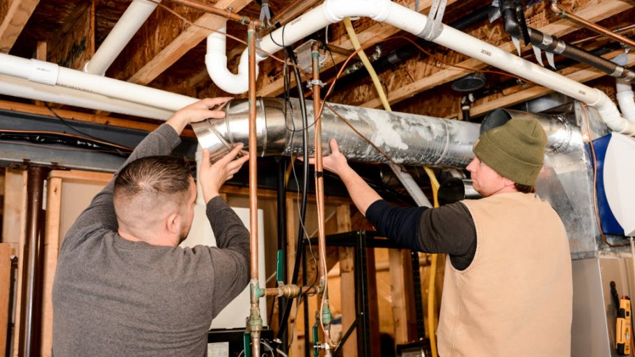 HVAC workers installing ductwork