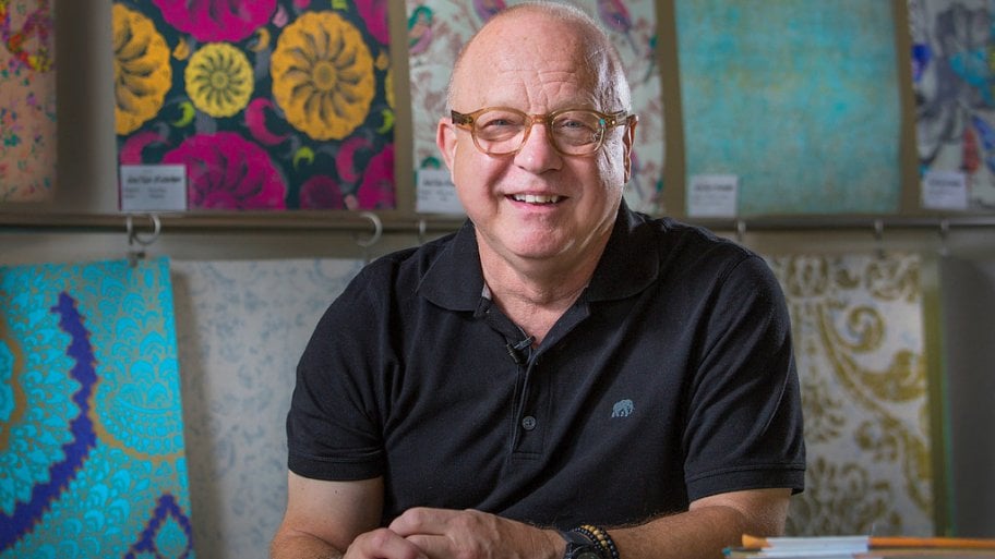 Artist Walter Knabe at his Indianapolis studio with custom wallpaper designs behind him