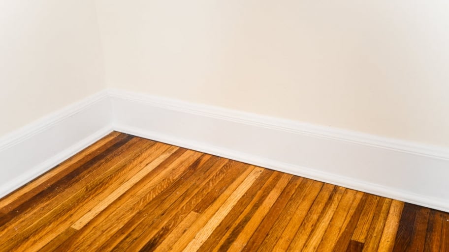 white baseboards on hardwood floor