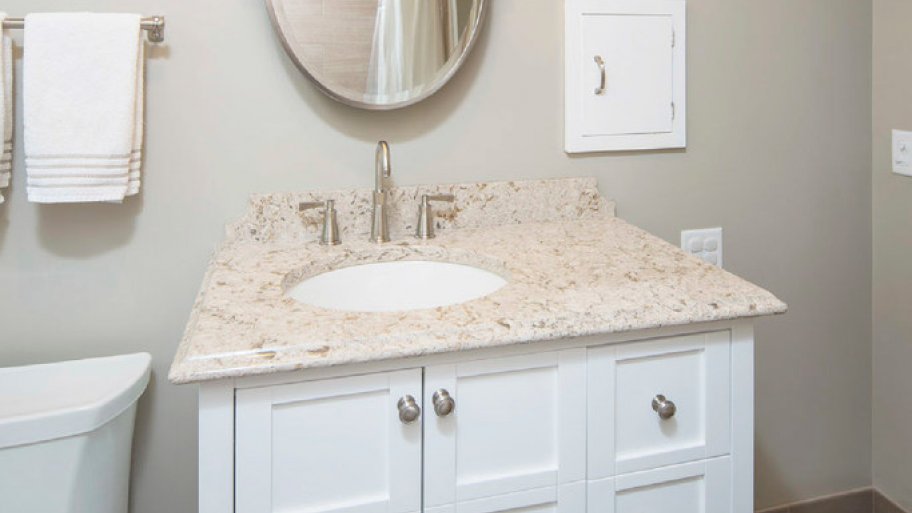 White bathroom vanity with granite countertop