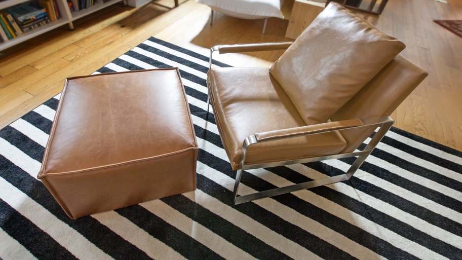 leather chair on black, white striped area rug