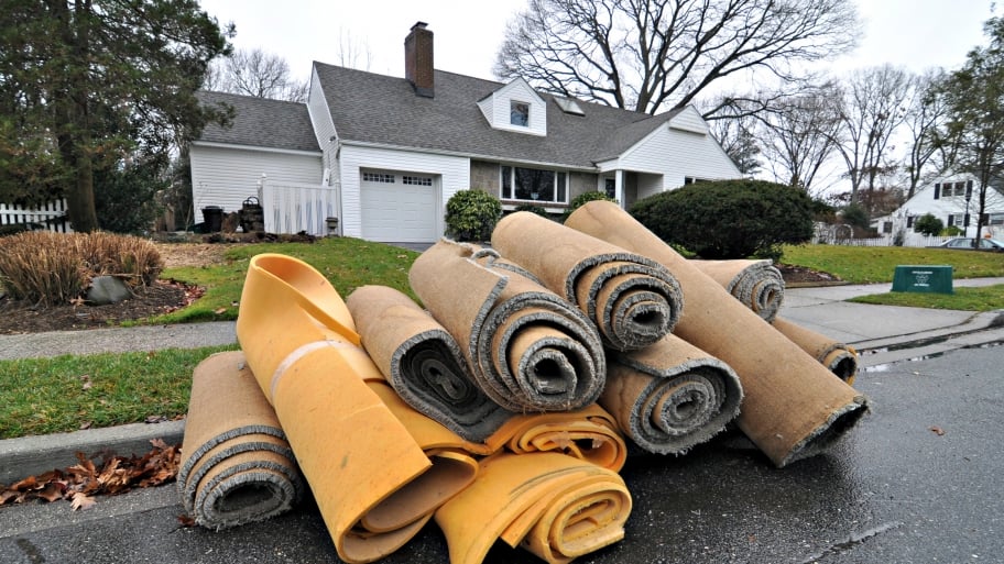 carpet rolls in front of a home