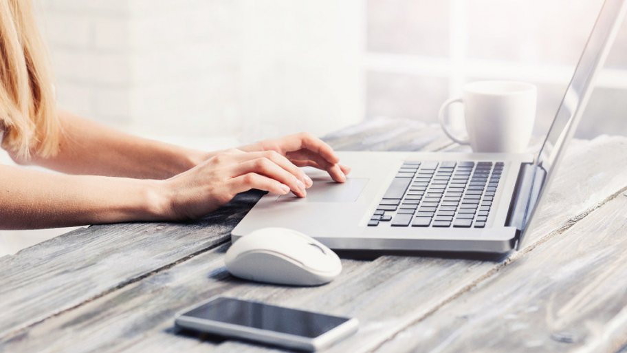 Hands on a laptop keyboard