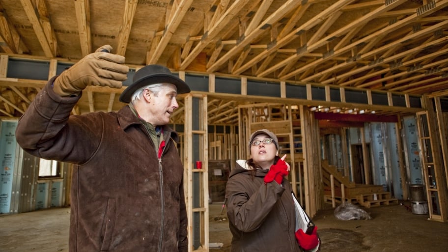 contractor and homeowner inspect construction site