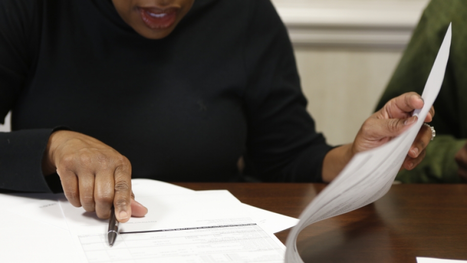 Home buyer signing paperwork at closing.