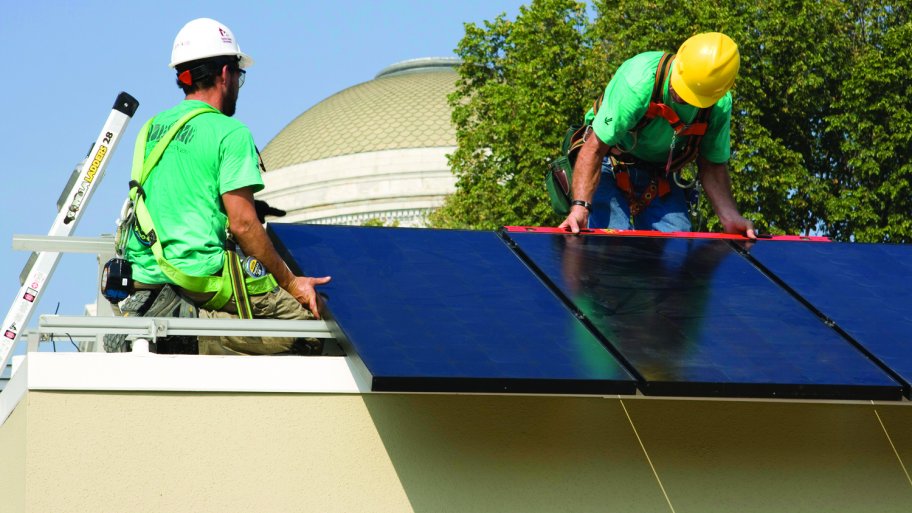two men on roof installing solar panels