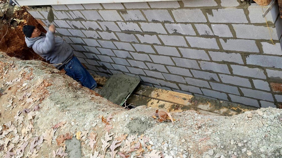 Worker building a support wall