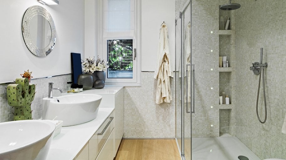 Side view of bathroom with two sinks and small mirror