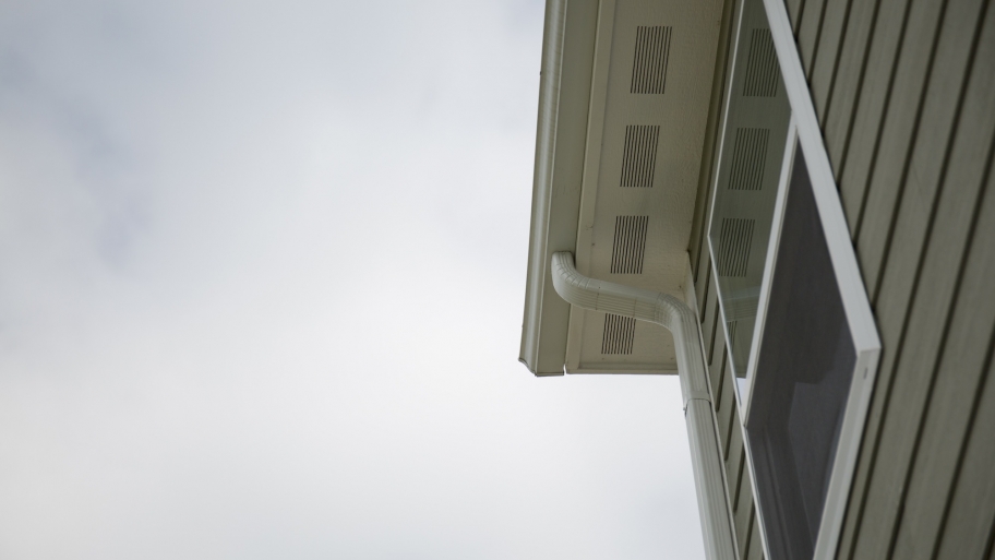 upward, side view of home exterior with siding and windows