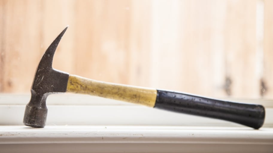 contractor's claw hammer sitting in window sill during remodeling project