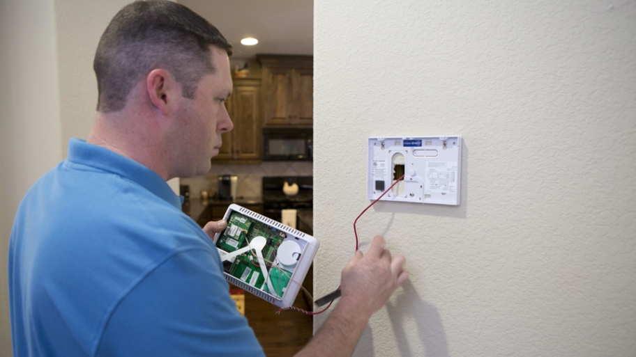 home security technician working on install