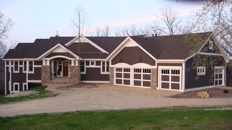 dark blue Craftsman home with white trim