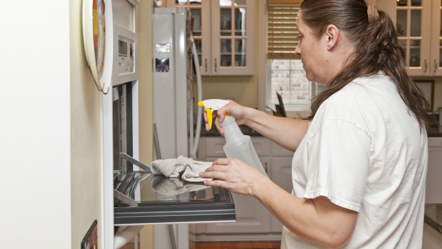 woman cleaning oven