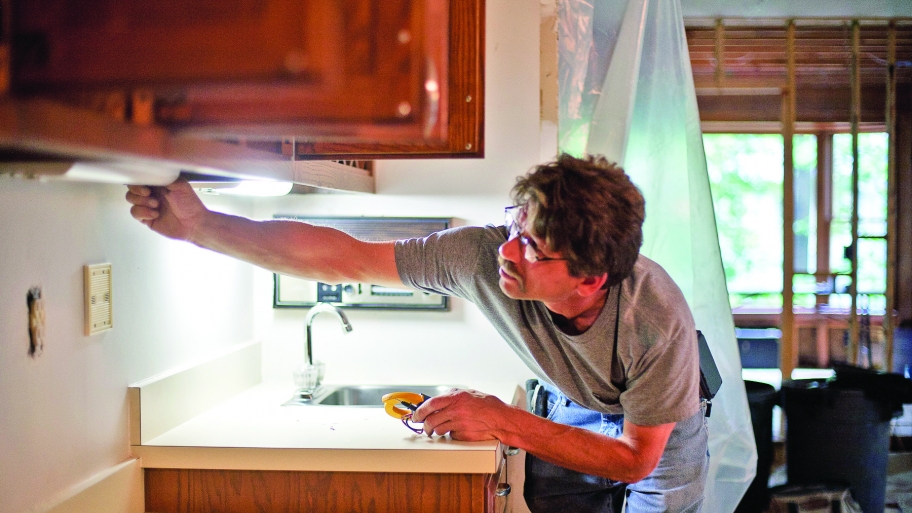 electrician checking lights during a kitchen remodel