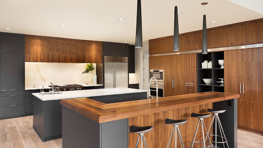 kitchen island with wood, gray cabinets, pendant lighting