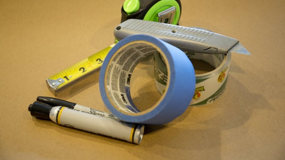 Tape, tape measure, box cutter, markers and toolbox