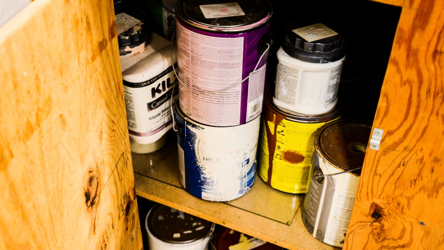 paint cans in a cabinet