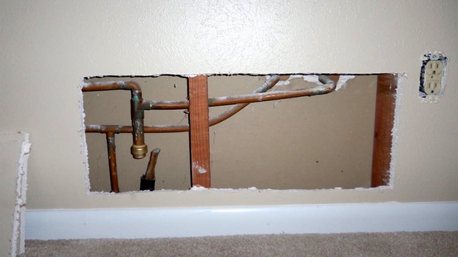 drywall cut out exposed copper water pipes