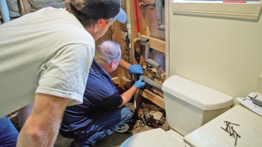 Plumbers check bathroom insulation