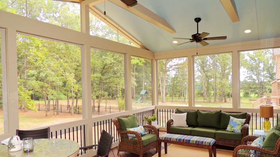 screened in porch with dining table and patio furniture set