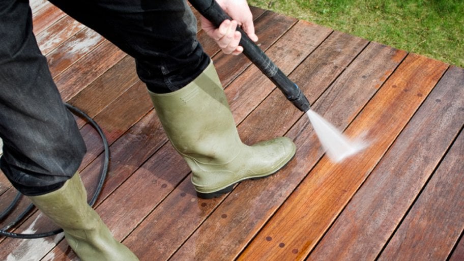 Pressure washer cleaning a deck